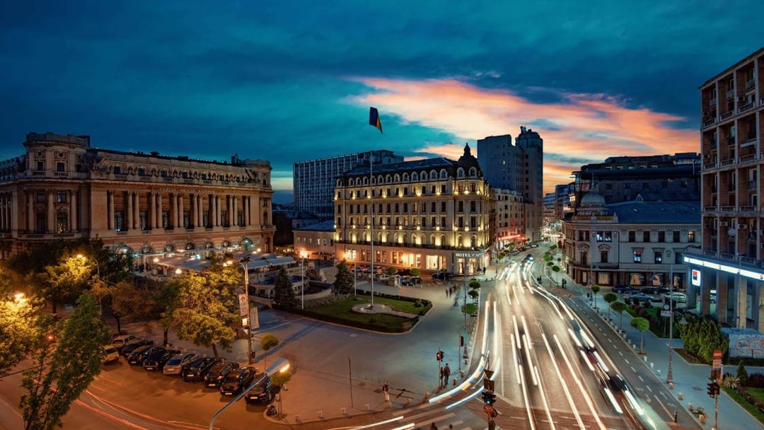 Cityscape at dusk with illuminated buildings and busy streets, After Dark City Tour.