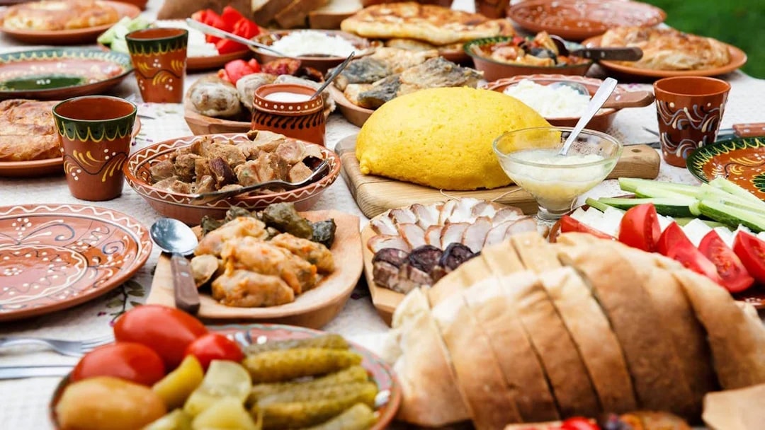 Traditional dinner spread with various dishes and bread, part of the After Dark City Tour.