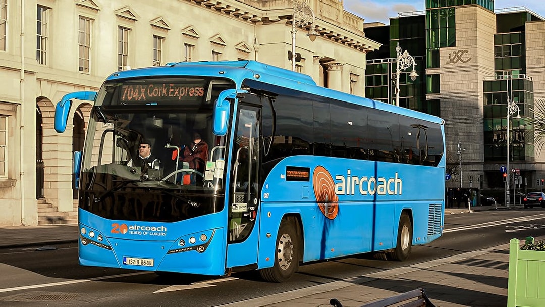 Dublin Aircoach bus on city street for airport transfers.