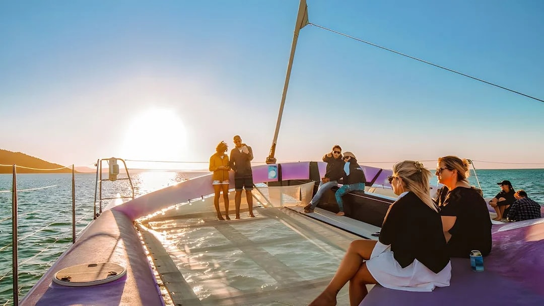 Sailing group enjoying sunset on Camira catamaran, Airlie Beach.