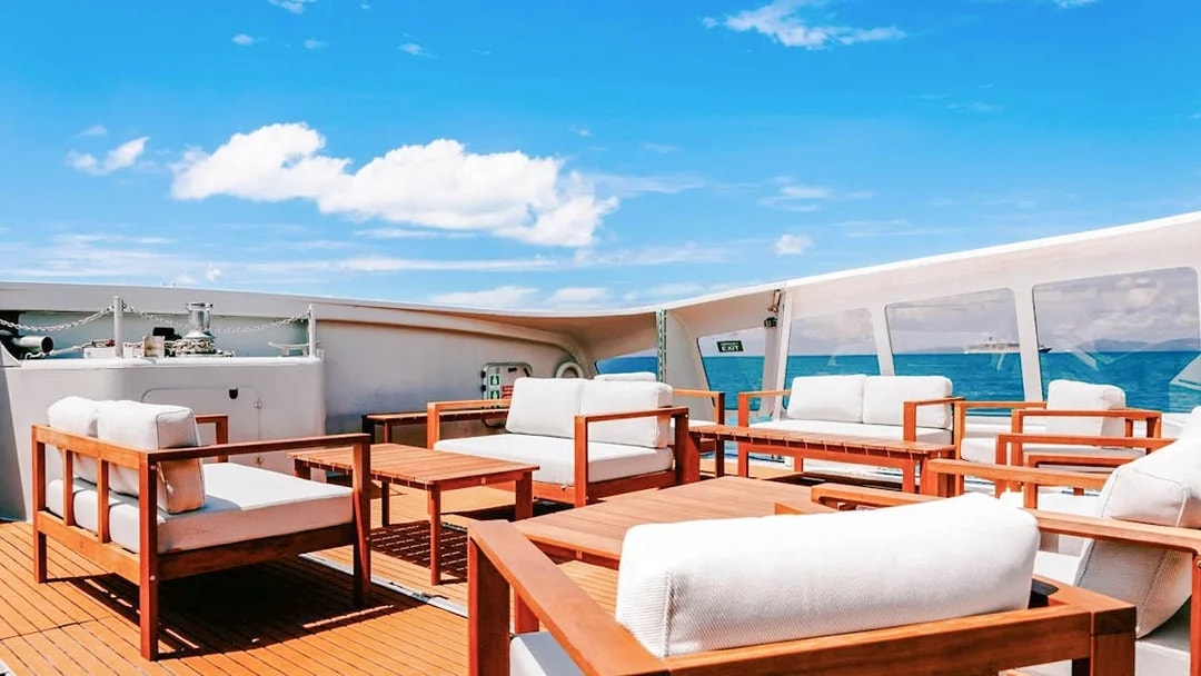 Outdoor seating area on a boat deck during ZigZag Whitsundays Day Tour.
