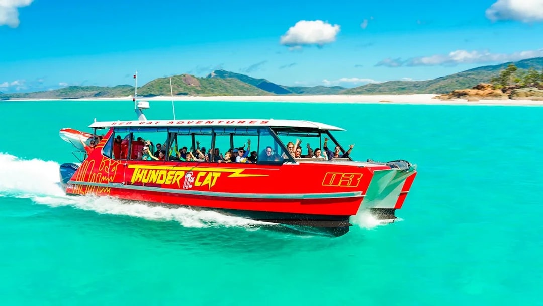 Thundercat boat cruising through turquoise waters in Whitsundays, Australia.