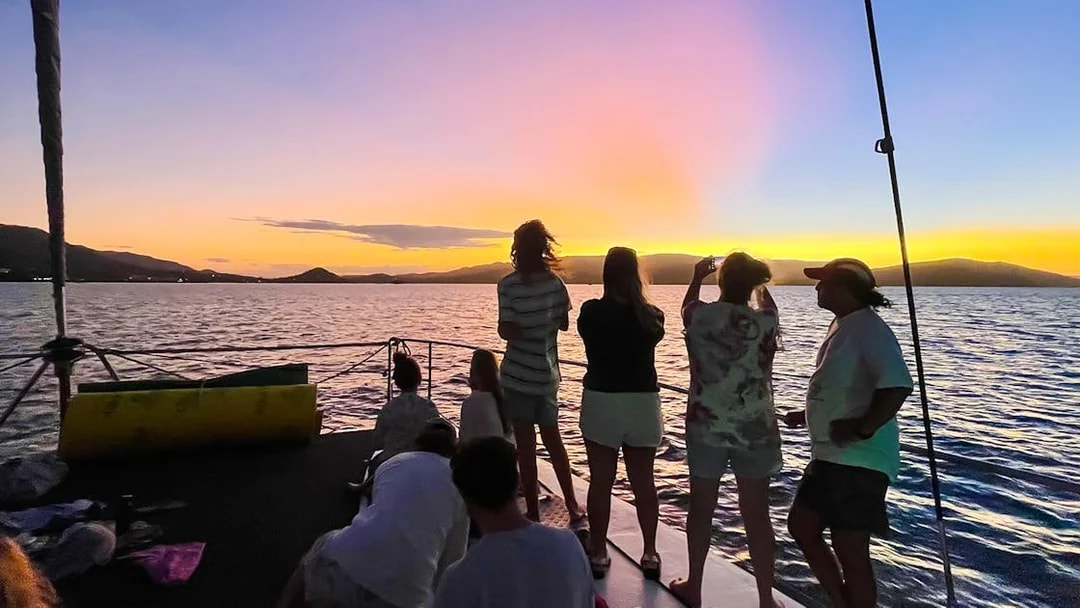 Tourists enjoying a sunset sail in the Whitsundays, Australia.