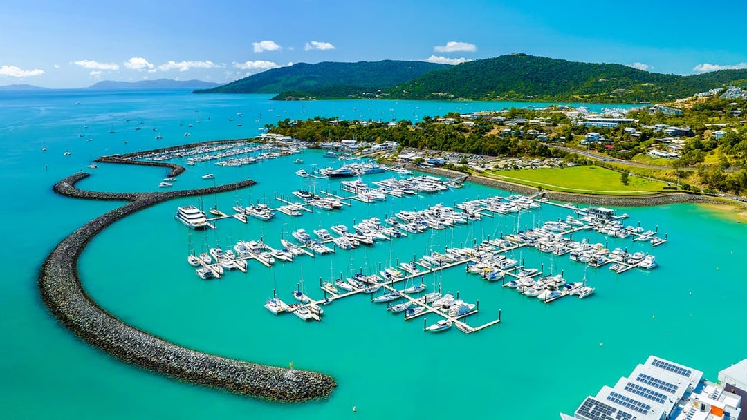 Coral Sea Marina in Airlie Beach with yachts and turquoise waters.