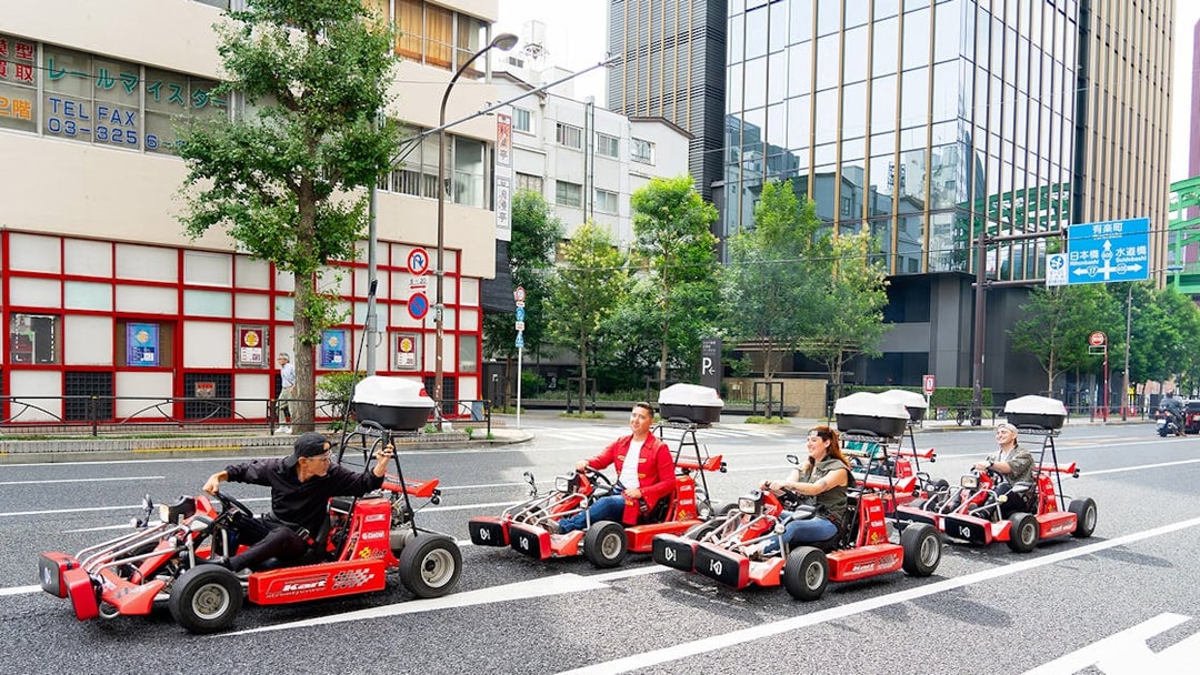 People driving go-karts on Akihabara streets in Tokyo.