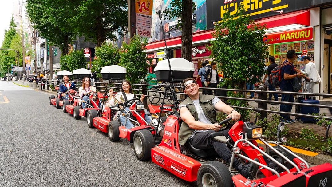 People enjoying Akihabara GoKart experience on a street in Tokyo.