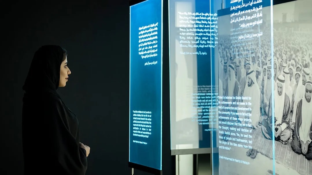 Visitor viewing historical exhibit at Al Shindagha Museum, Dubai.