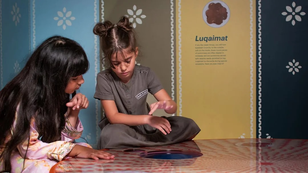 Children exploring interactive exhibit at Al Shindagha Museum.