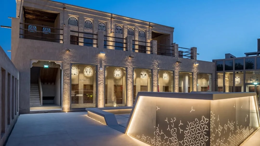 Al Shindagha Museum exterior with illuminated traditional architecture in Dubai.