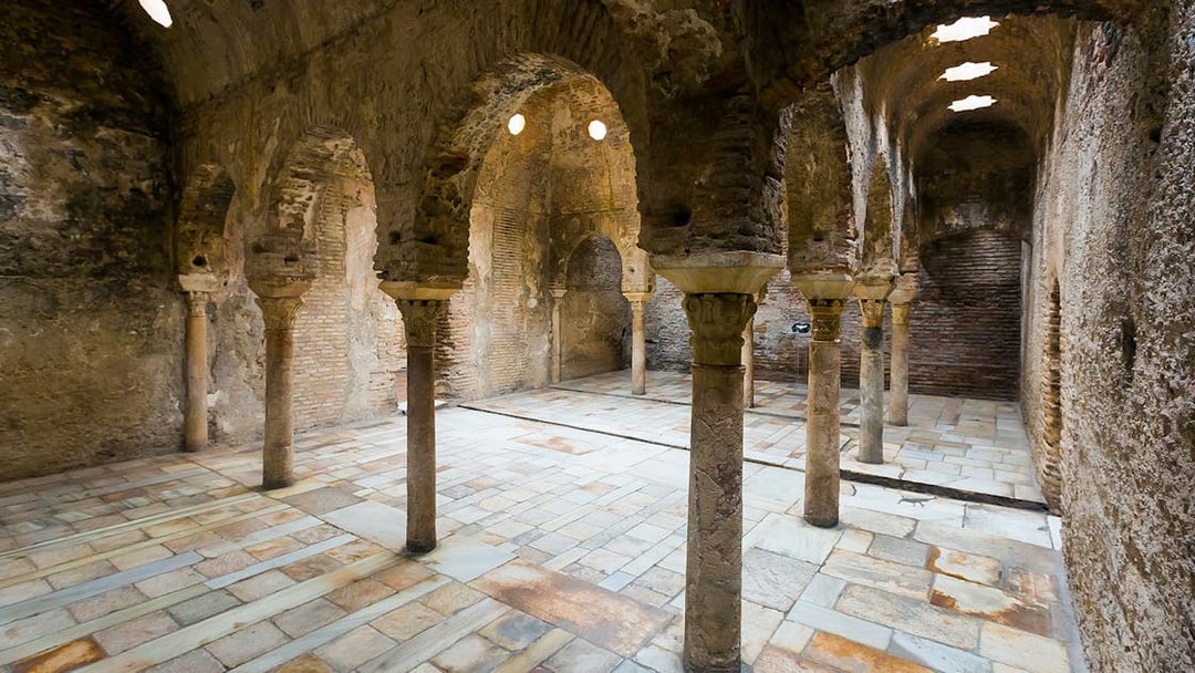 Interior of ancient Arab bathhouse with stone arches in Albaicin, Granada, Spain.