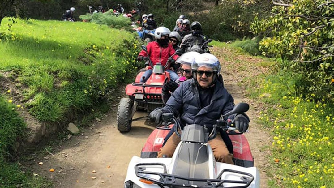 Group riding quad bikes on a trail through Alcantara Gorges, Sicily.