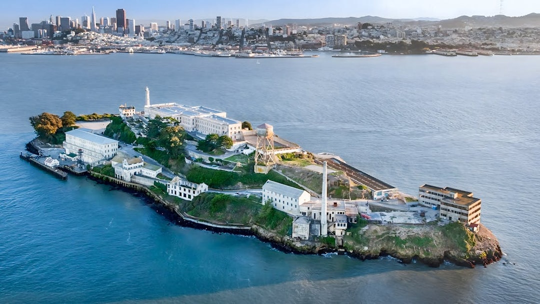 Aerial view of Alcatraz Island with San Francisco skyline in the background.