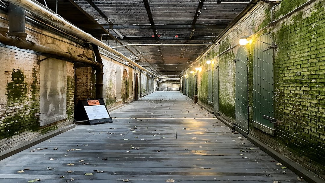 Walkway to prison cells with mossy walls on Alcatraz Island, San Francisco.