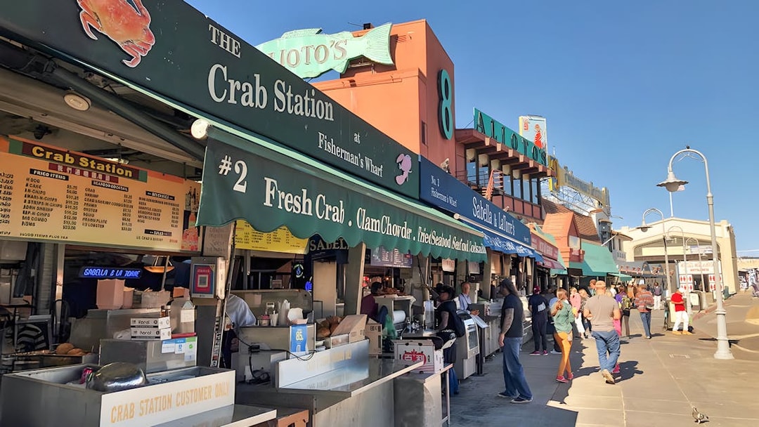 Crab stalls at Fisherman's Wharf, San Francisco Waterfront, with people browsing.