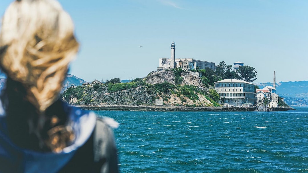 Visitor viewing Alcatraz Island from a boat on San Francisco Bay.