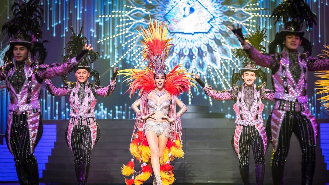 Performers in vibrant costumes on stage at Alcazar Cabaret Show, Pattaya.