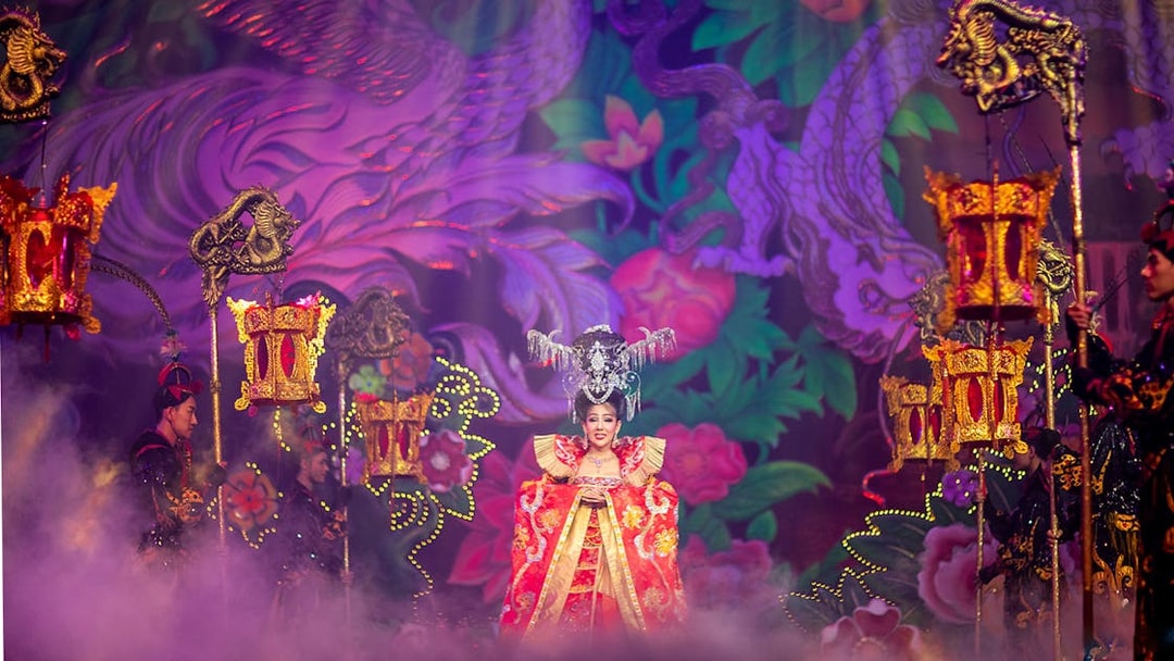 Performer in ornate costume on stage at Alcazar Cabaret Show, Pattaya, Thailand.