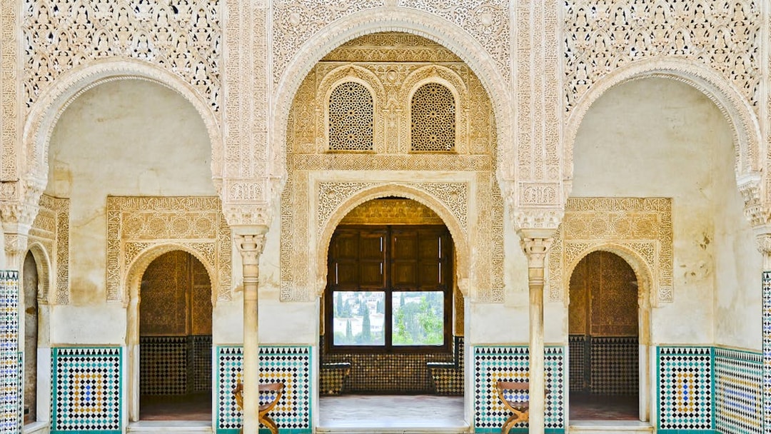 Intricate Moorish arches and tilework in Alhambra, Granada, Spain.