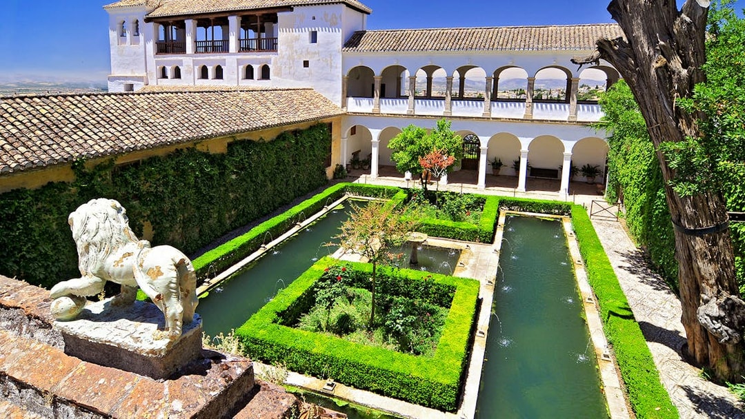 Alhambra's Generalife gardens with fountains and hedges, Granada, Spain.