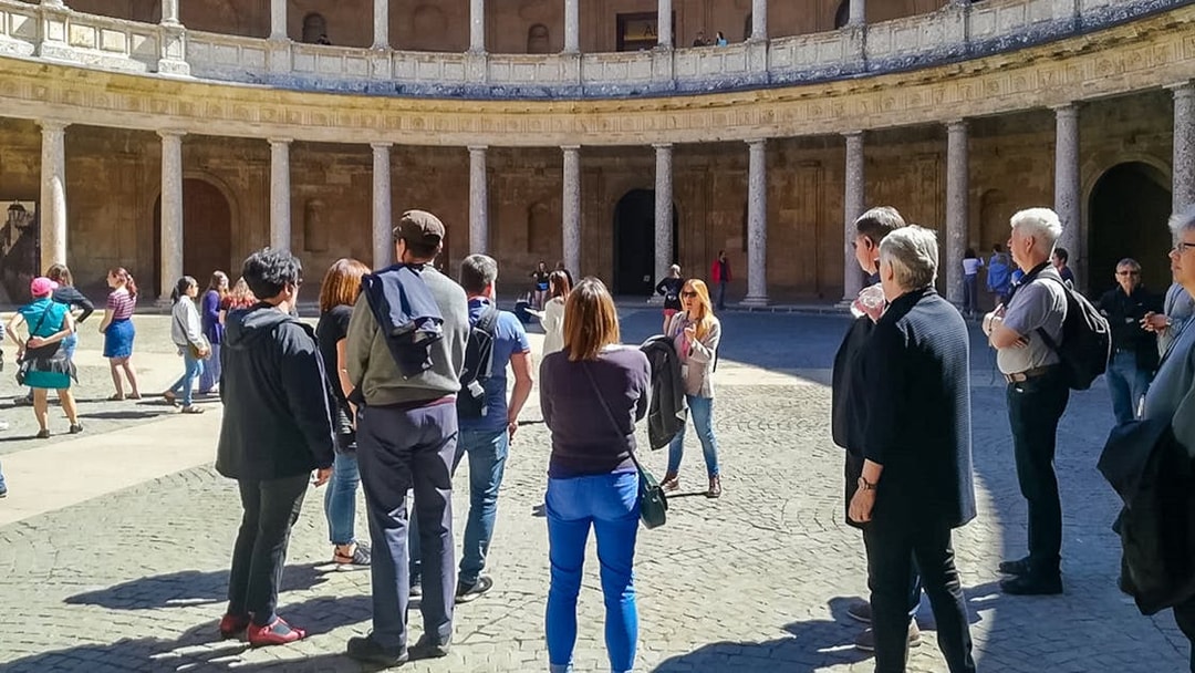 Group of tourists in courtyard during Alhambra and Generalife guided tour, Granada.