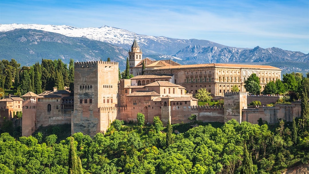 Alhambra palace complex with Sierra Nevada mountains in Granada, Spain.