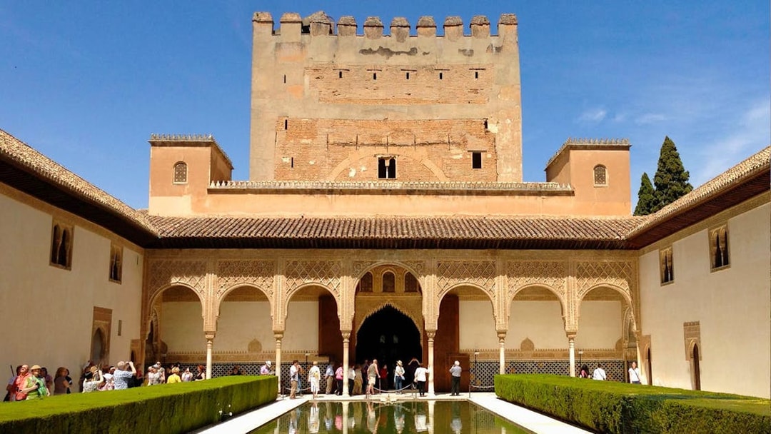 Alhambra courtyard with reflecting pool and Nasrid Palaces, Granada, Spain.