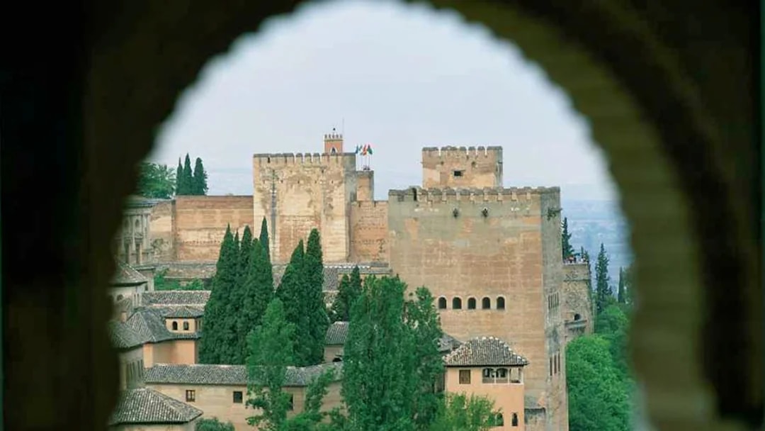 Alhambra fortress view through archway, Granada, Spain.