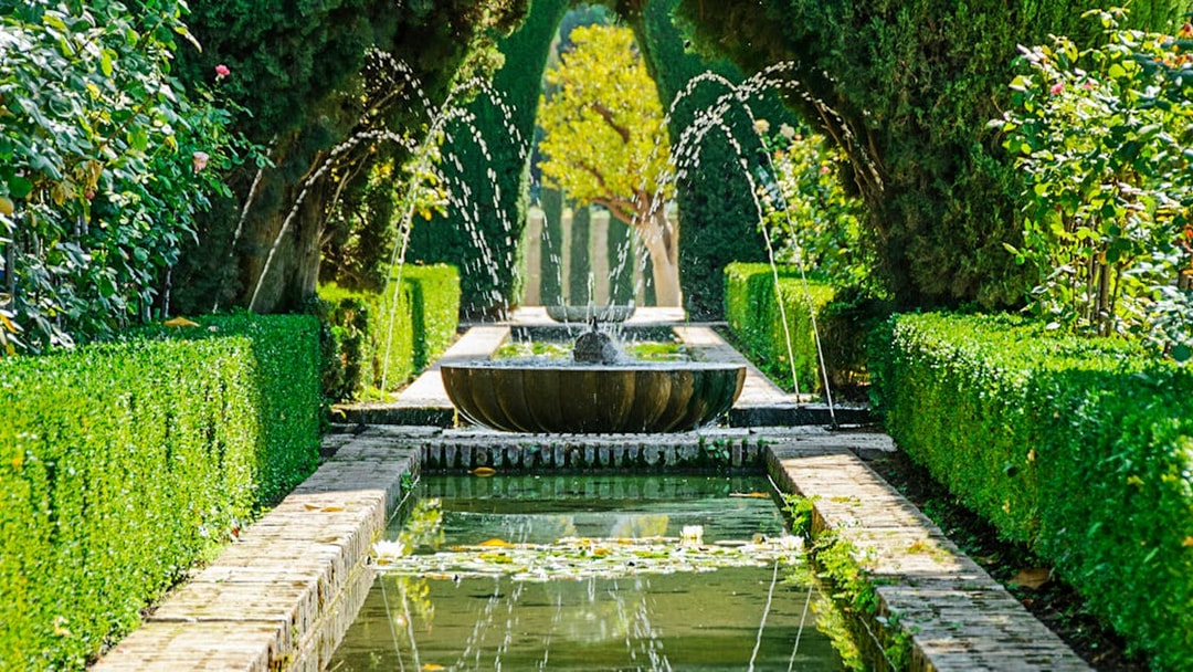 Fountain and garden path in Alhambra, Granada, Spain.