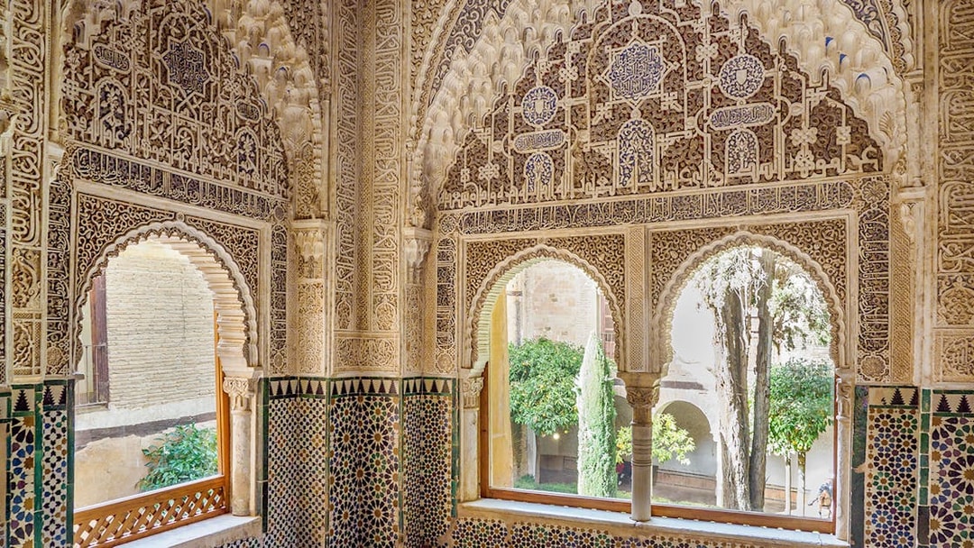 Intricate Moorish architecture inside Alhambra's Nasrid Palaces, Granada, Spain.