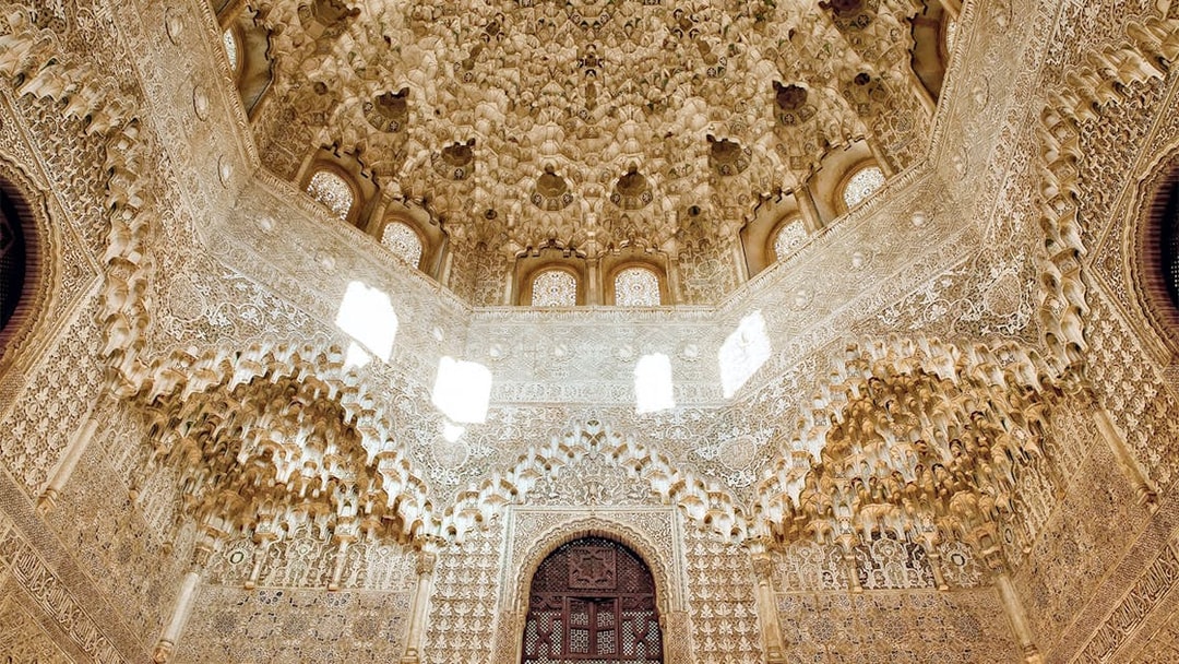 Intricate stucco ceiling and arches in the Nasrid Palace, Alhambra, Granada.