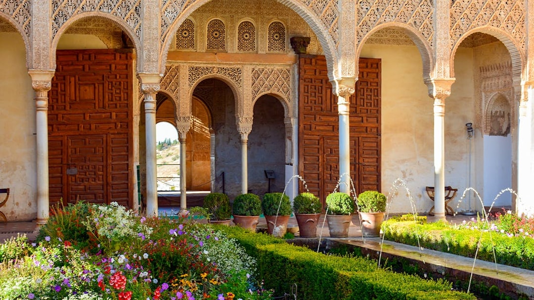 Palace of the Patio de la Acequia del Generalife, Alhambra with arches and garden.
