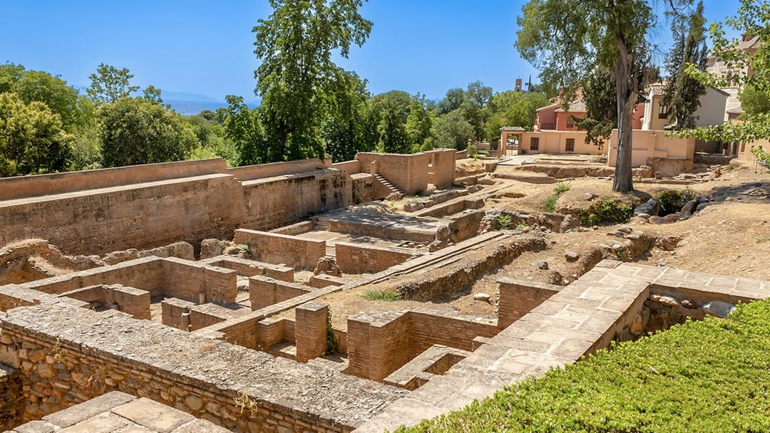 Ancient ruins surrounded by greenery on the Alhambra Surroundings Tour.