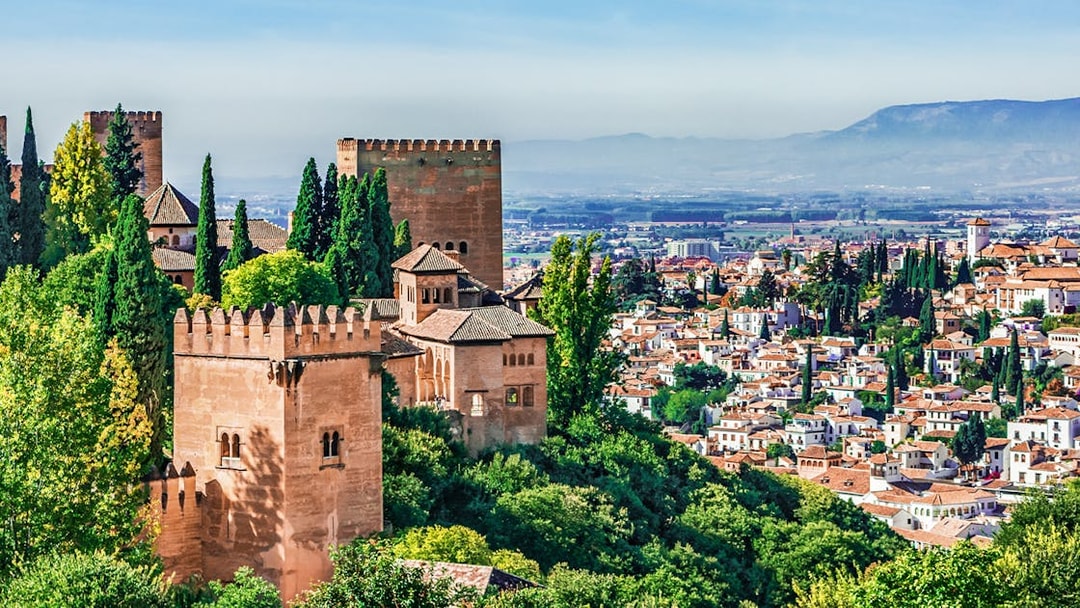 Panoramic view of Alhambra with surrounding cityscape in Granada, Spain.