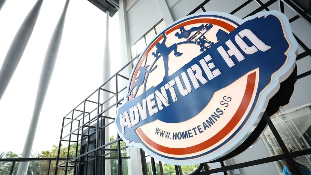 Adventure HQ entrance sign with website URL, promoting All-Access Pass.