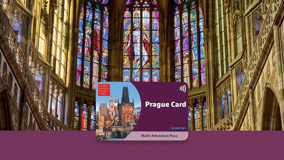 Prague Card displayed against stained glass windows in a historic cathedral.