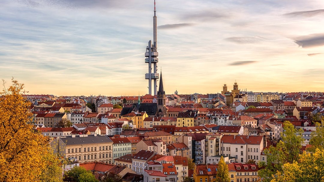 Prague skyline with Žižkov Television Tower and historic buildings.