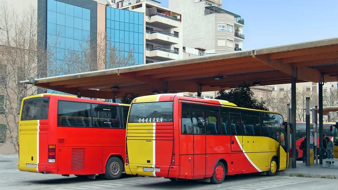 Buses parked at Ibiza station for airport transfer.