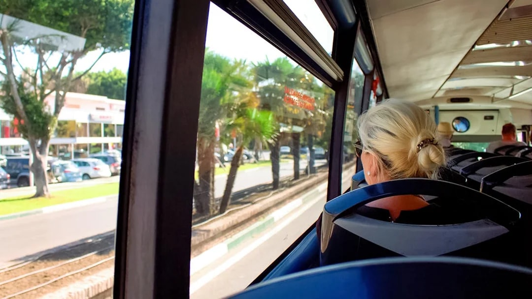 Bus ride from Ibiza Airport to Ibiza city with passengers seated.