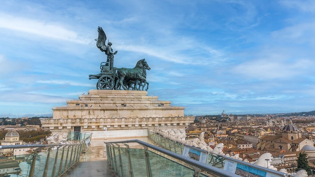 View from Altar of the Fatherland, Rome, with chariot statue and cityscape.
