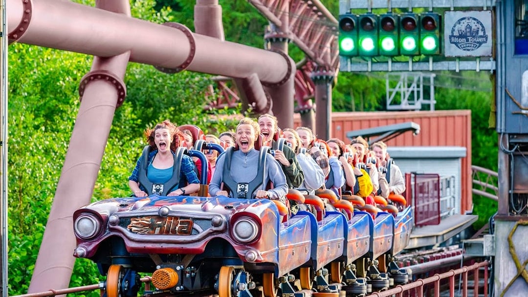 Riders on the Rita rollercoaster at Alton Towers, experiencing high-speed thrills.
