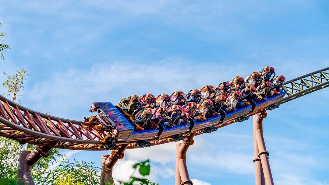 Riders on the Rita rollercoaster at Alton Towers, UK, speeding on a curved track.