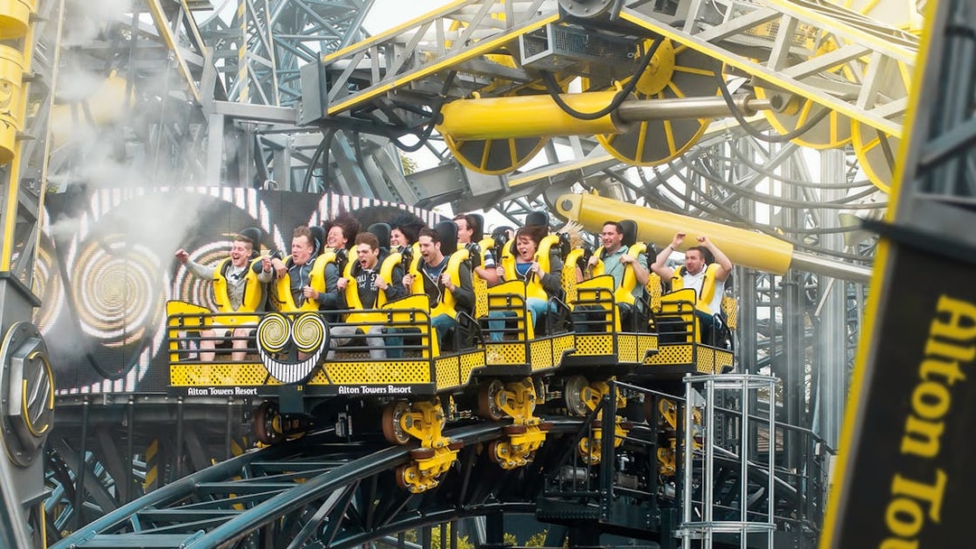 Riders on The Smiler roller coaster at Alton Towers, UK, experiencing a thrilling loop.