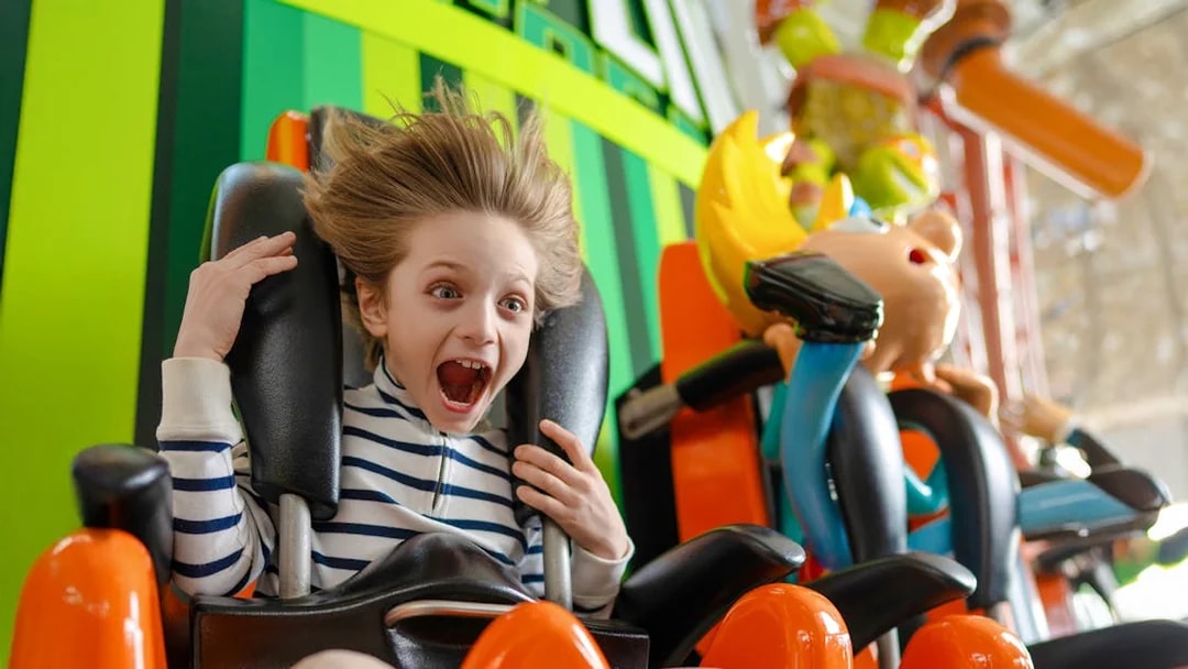 Kid enjoying the Skyline Scream ride at Nickelodeon Universe.