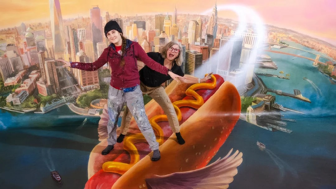 Guests posing on a flying hot dog at TiLT Interactive Museum, American Dream.