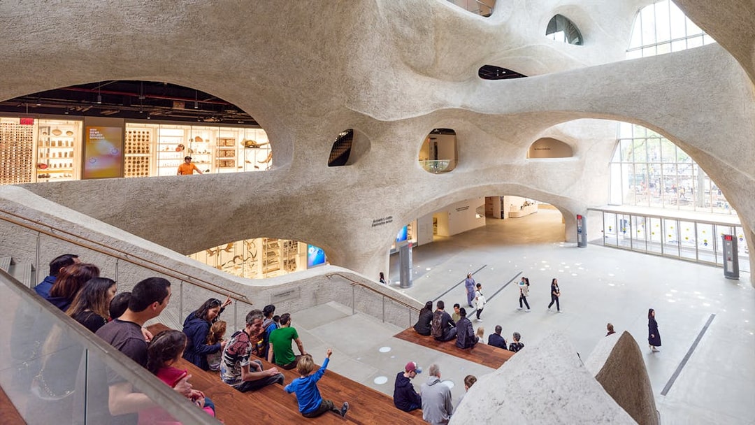 Visitors seated in the American Museum of Natural History's modern atrium, New York City.