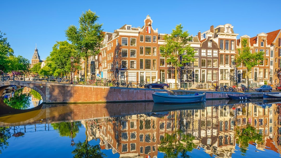 Prinsengracht canal with historic buildings and boats in Amsterdam city.