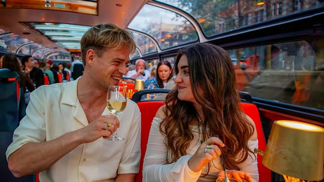 Guests enjoying wine on a scenic dinner cruise.