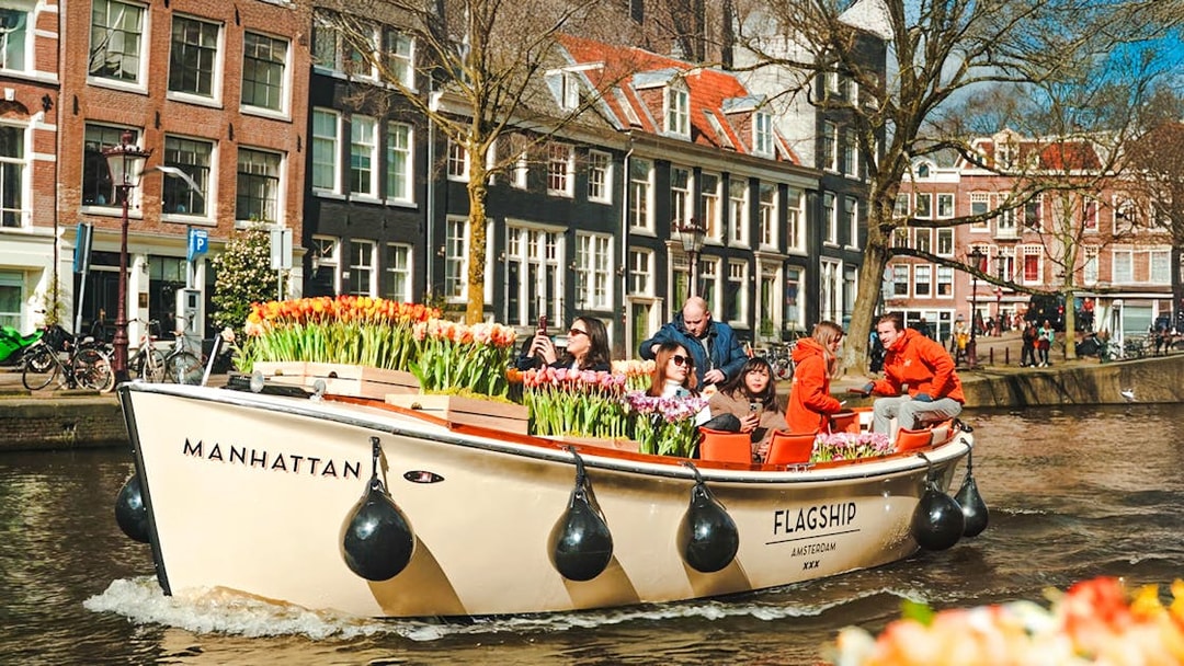 Guests enjoying a tulip tour boat ride on Amsterdam canal.