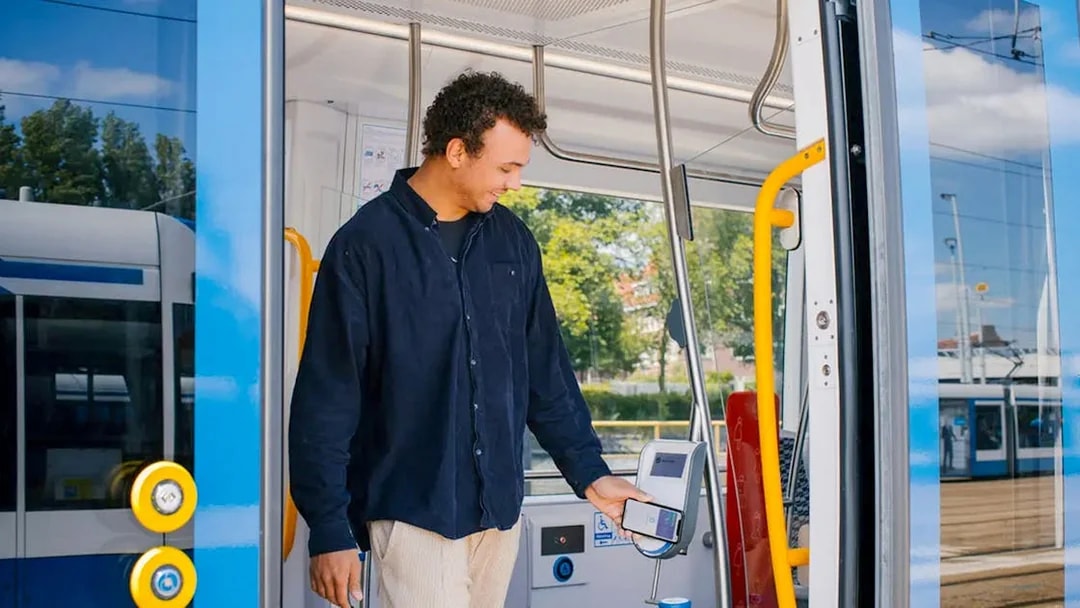 Man using GVB multi-day ticket on Amsterdam tram.