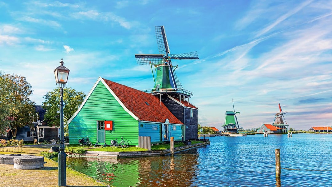 Windmill and green house by the water in Zaanse Schans, Netherlands.